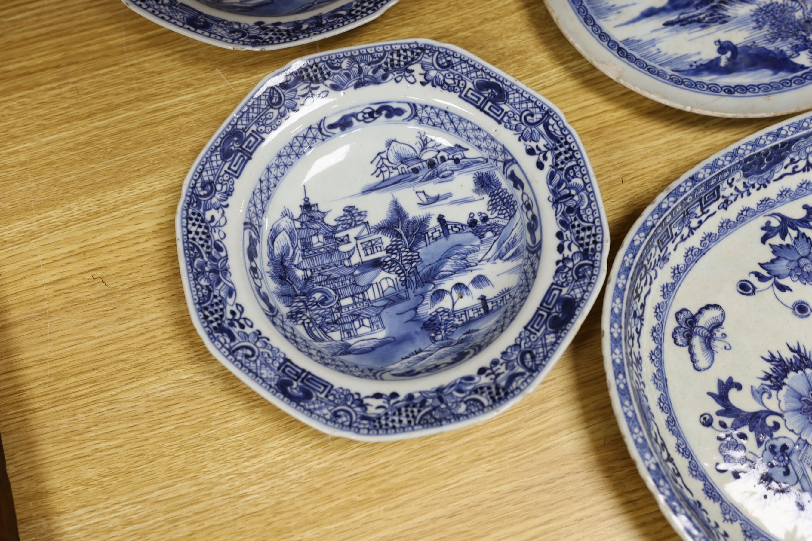 A selection of severn 18th century Chinese export blue and white dishes, largest 35cm wide